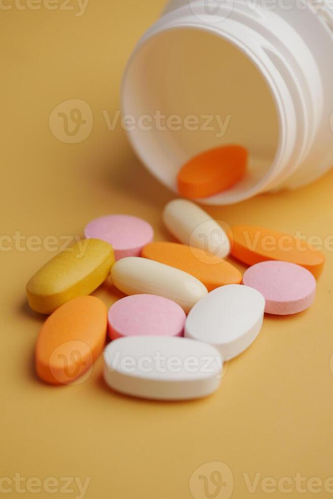 An Array of Assorted Vitamins and Medications Displayed on a Bright Yellow Surface photo