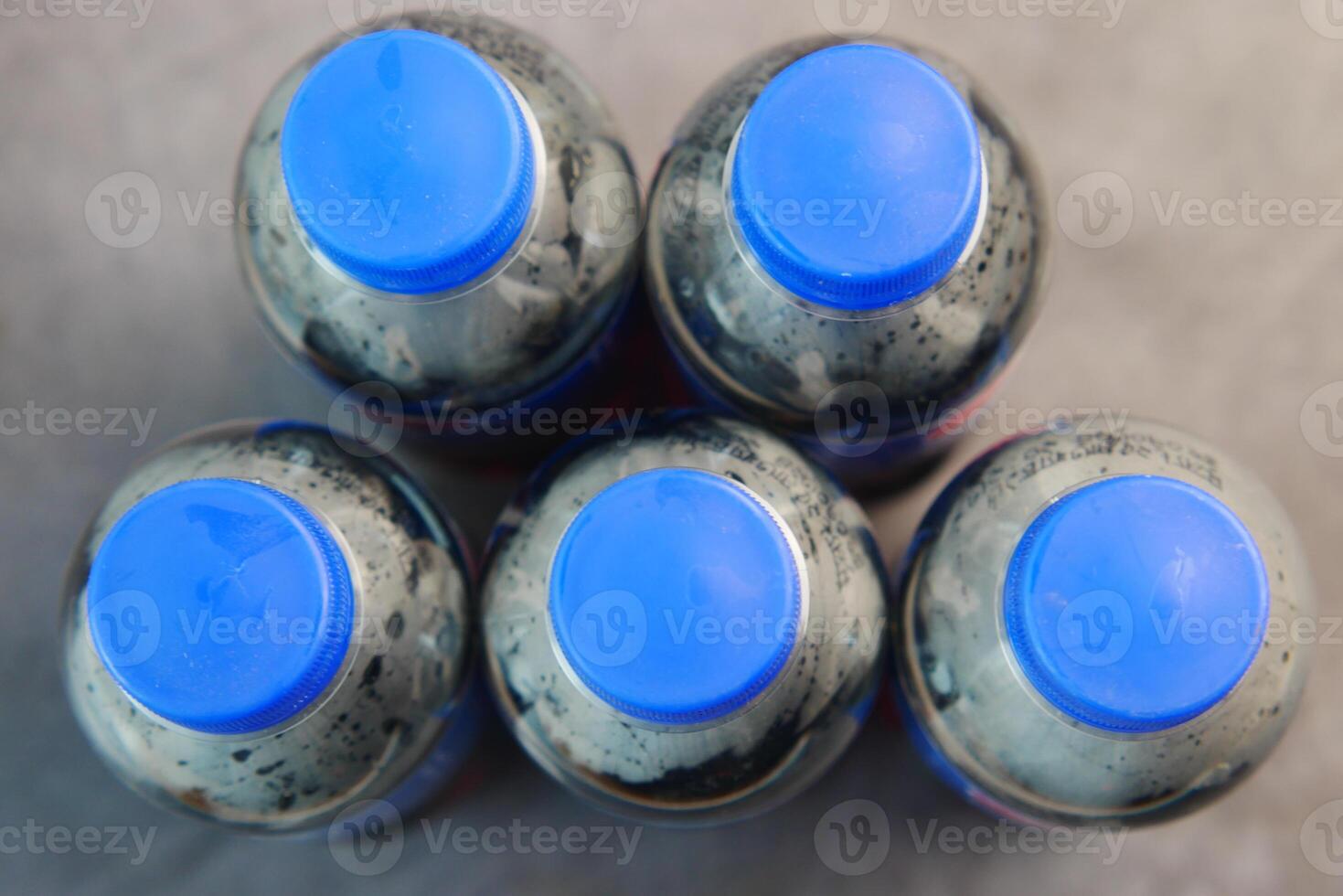An Overhead View of Bottles Featuring Striking Blue Caps and More photo
