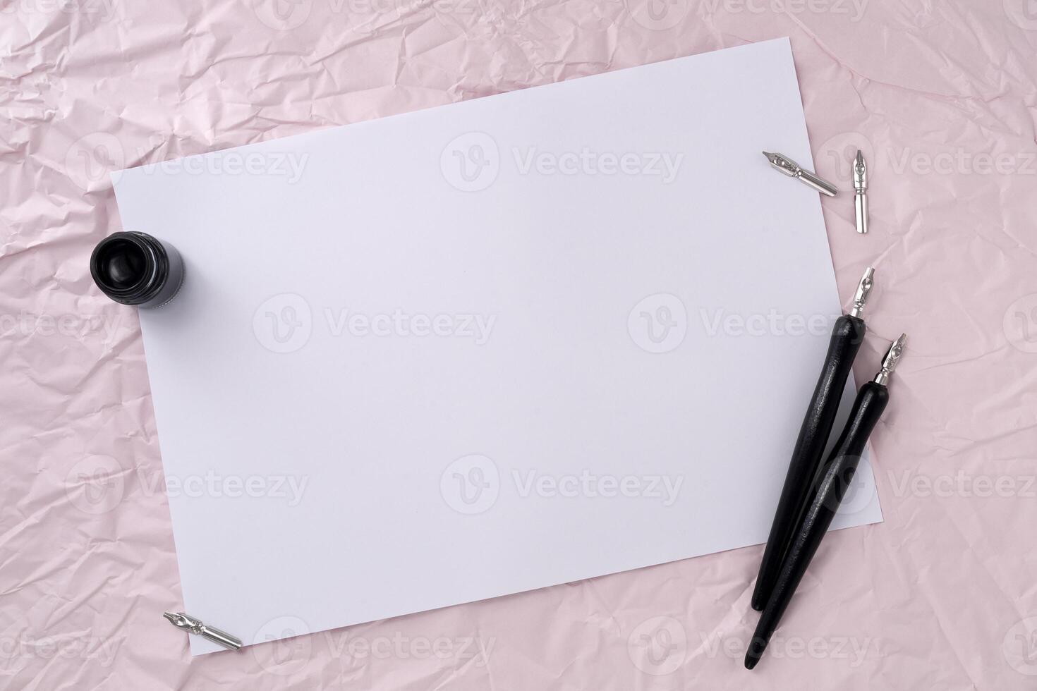 Paper with two dip pen on wrinkled paper texture background. photo