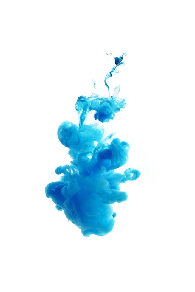 Blue ink dropped in to water isolated white background. Abstract color dissolving in water photo
