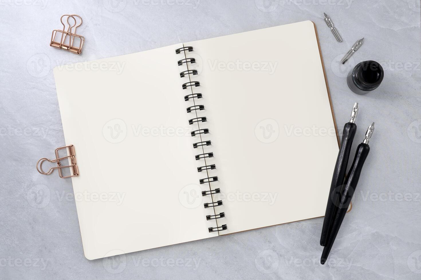 Blank book with two dip pen on stone texture background. photo