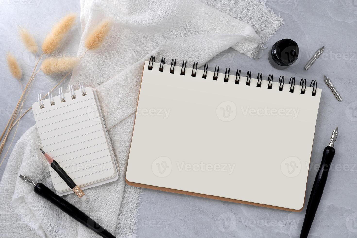Blank book and note with dip pen on stone texture background. photo