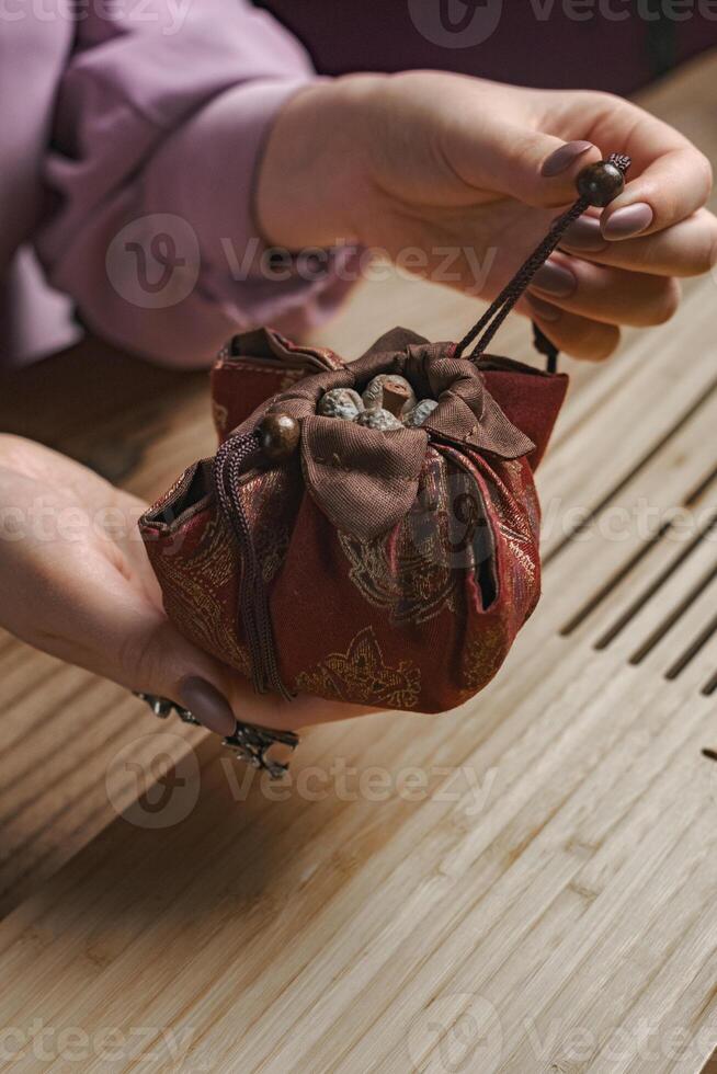 Elegant and Stylish Red Fabric Pouch Featuring a Beautiful Decorative Closure Design photo