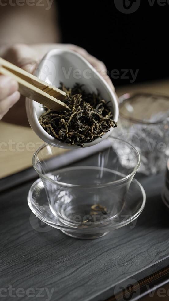 Engaging in a beautiful tea ceremony featuring loose leaves, exquisite teaware, and rich aroma photo