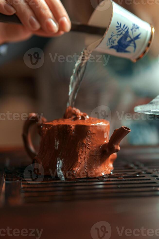 Pouring water carefully into a beautiful, miniature teapot creates a tranquil, cozy moment photo