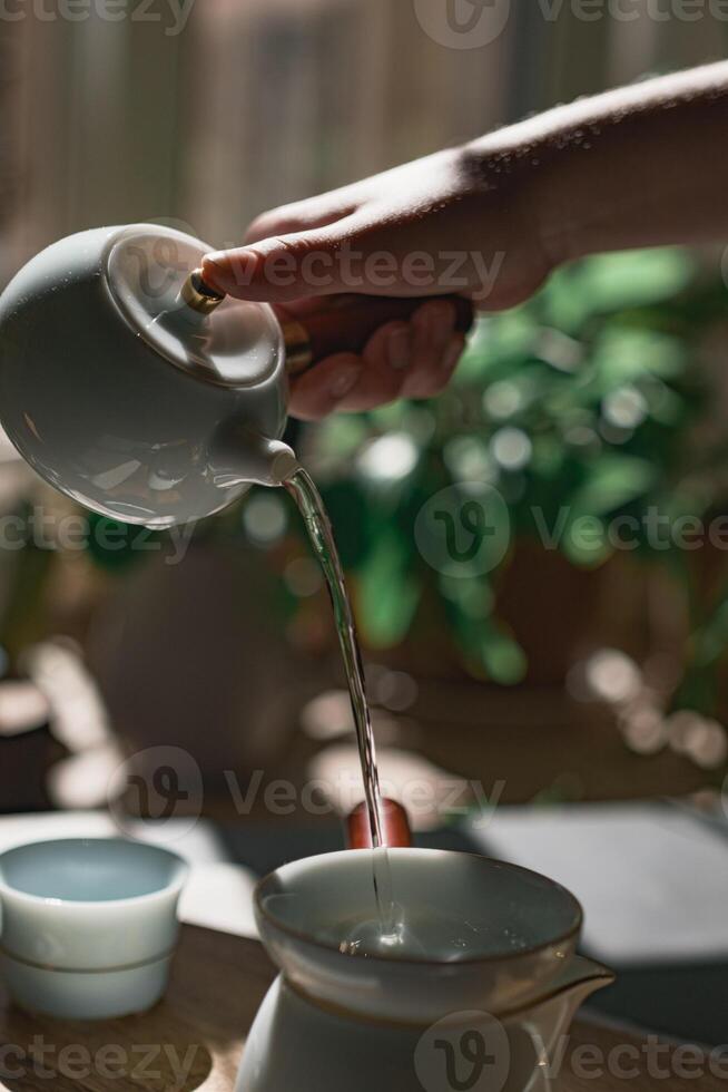 The Art of Elegant Tea Pouring in Soft Natural Light Creating a Serene Atmosphere photo