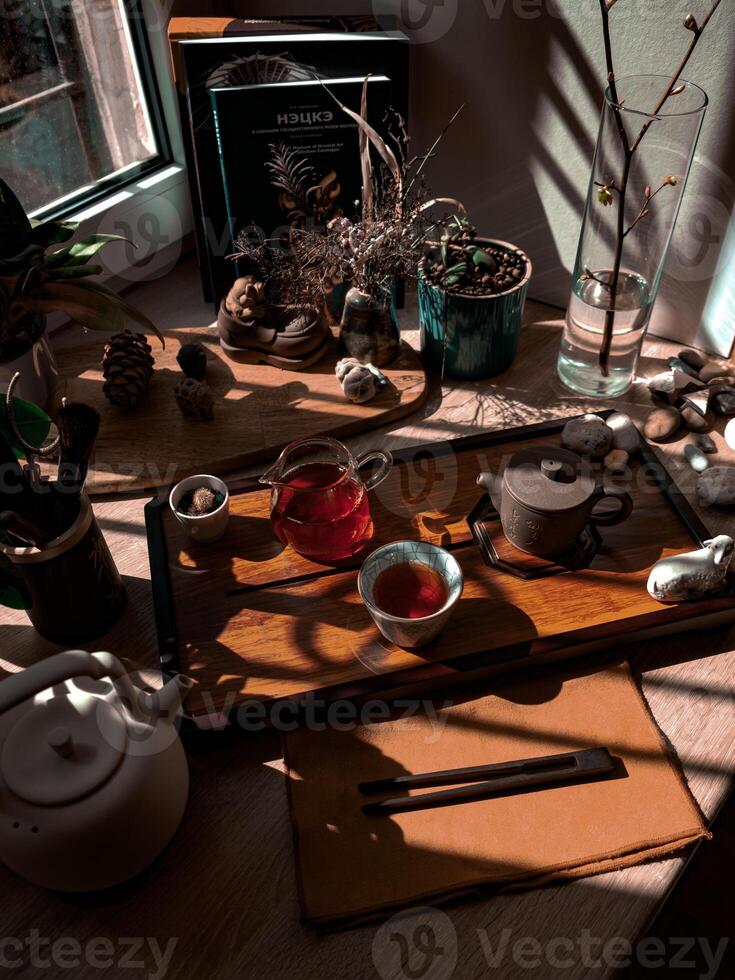 Enjoy a serene tea setup with natural light and botanical accents for a delightful experience photo