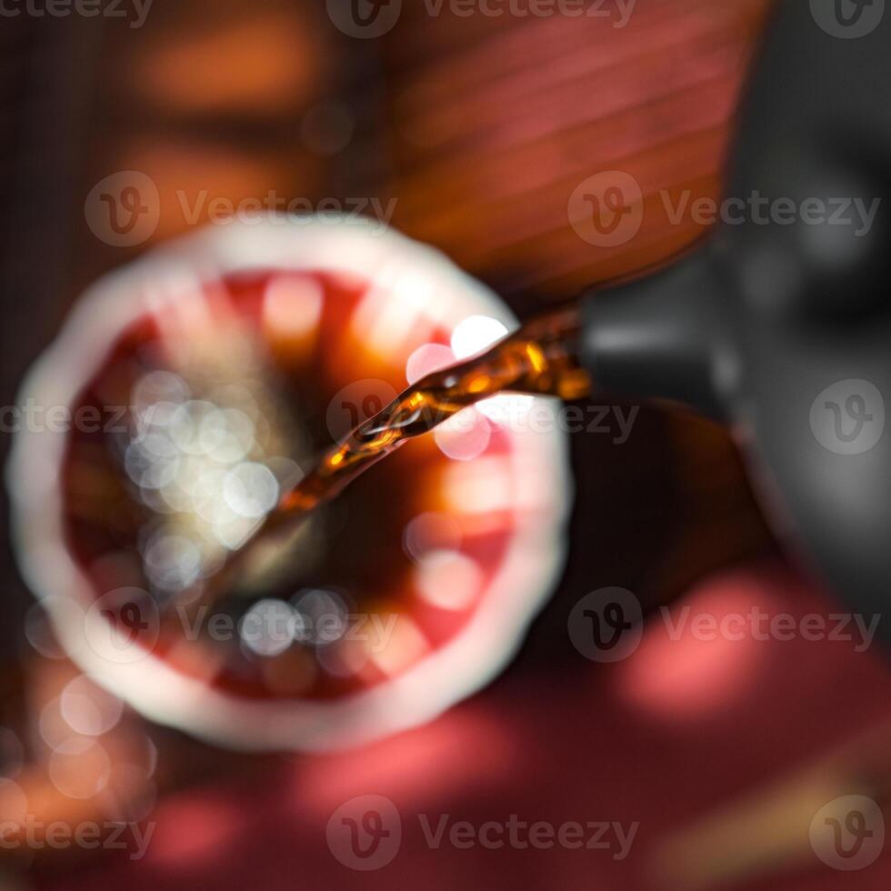 Tea pours from a beautifully crafted teapot into a delicate cup, enhancing the moment photo