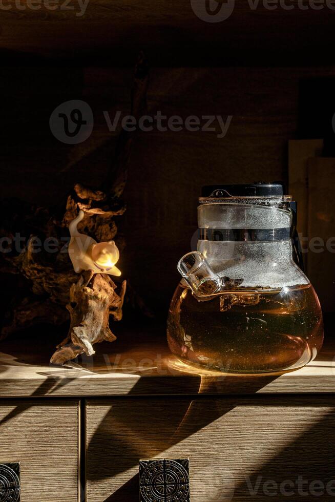 An Artistic Glass Jar filled with Liquid beautifully placed on a Wooden Shelf for display photo