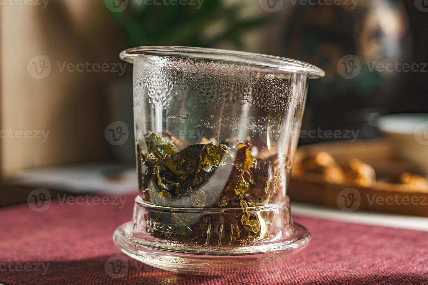 Beautiful Glass Teapot filled with Herbal Tea Leaves in a Cozy and Inviting Setting photo
