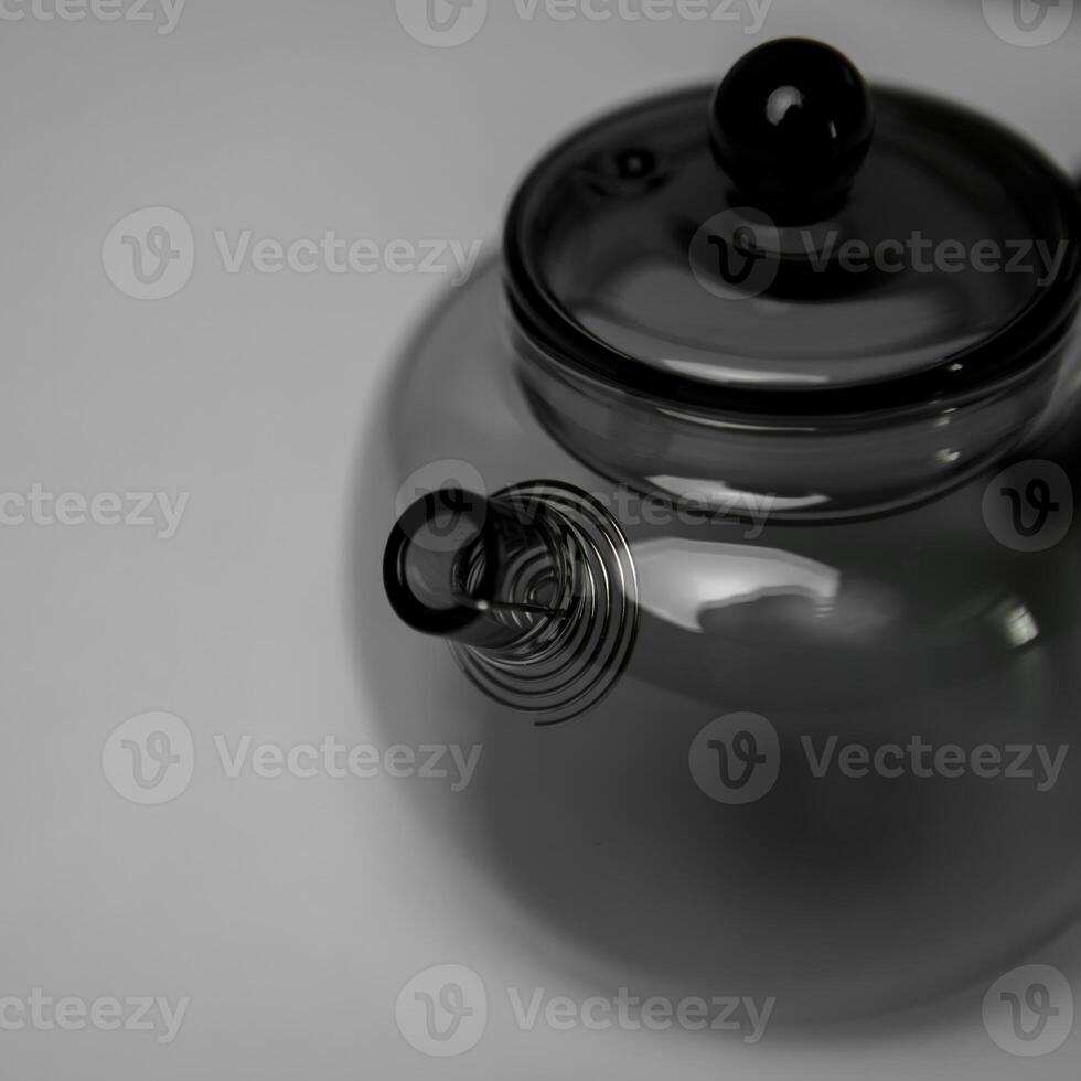 A Stylish and Modern Glass Teapot that Features a Unique and Intriguing Spout Design photo
