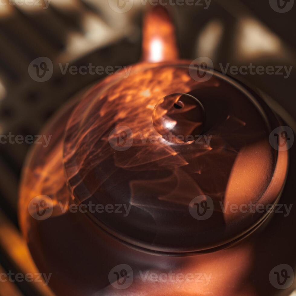 An Elegant Teapot Featuring Captivating Light Reflections That Enhance Its Beauty photo