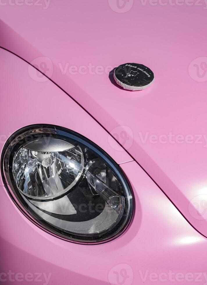 This is a Stylish Pink Car which has Unique Design Features that stand out beautifully photo