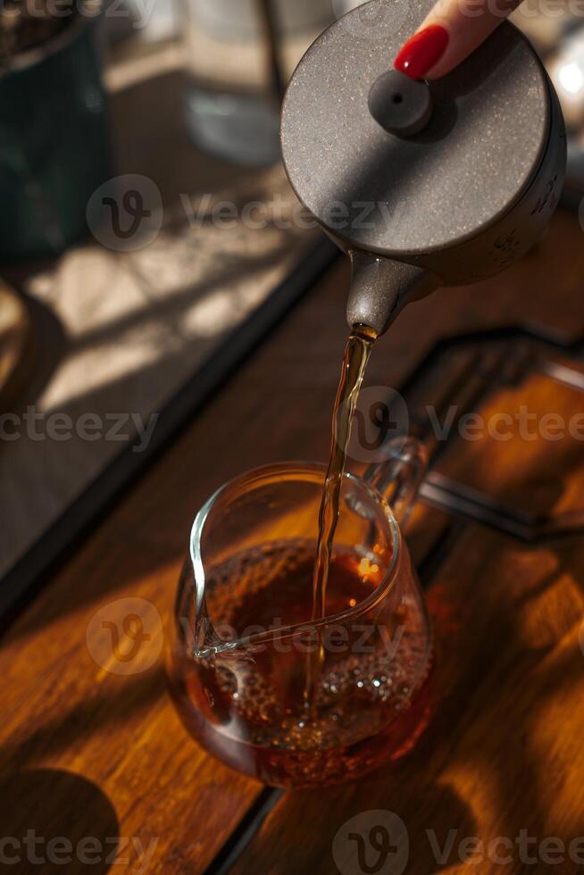 Pouring hot tea into a beautiful cup on a cozy afternoon adds a touch of tranquility photo