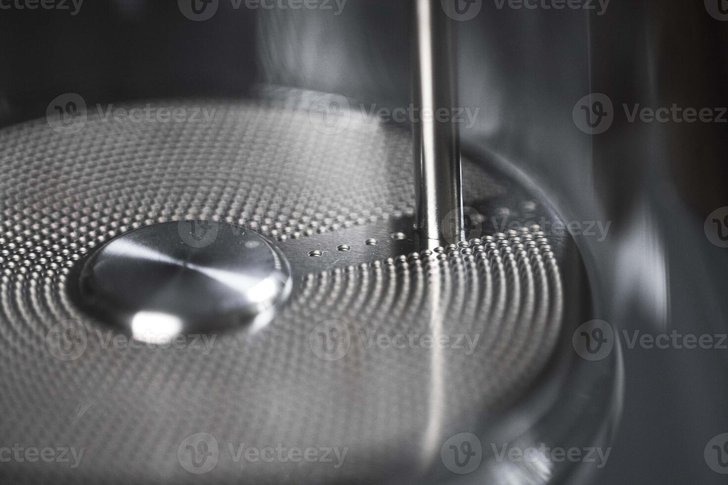 A closeup of a modern kitchen appliance component highlighting intricate design and craftsmanship photo