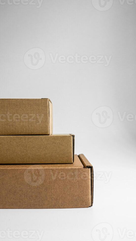Multiple Stacked Brown Boxes Arranged Neatly Against a Neutral Background for Clarity photo
