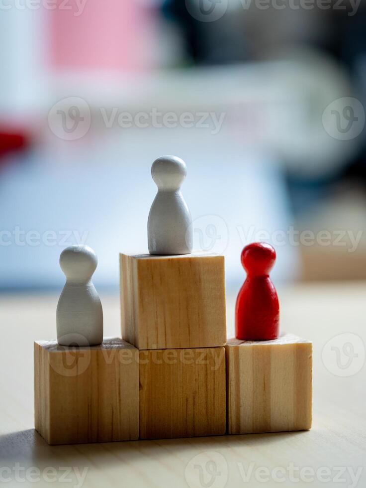 Teamwork and progress wooden figures on blocks in an office space concept photo