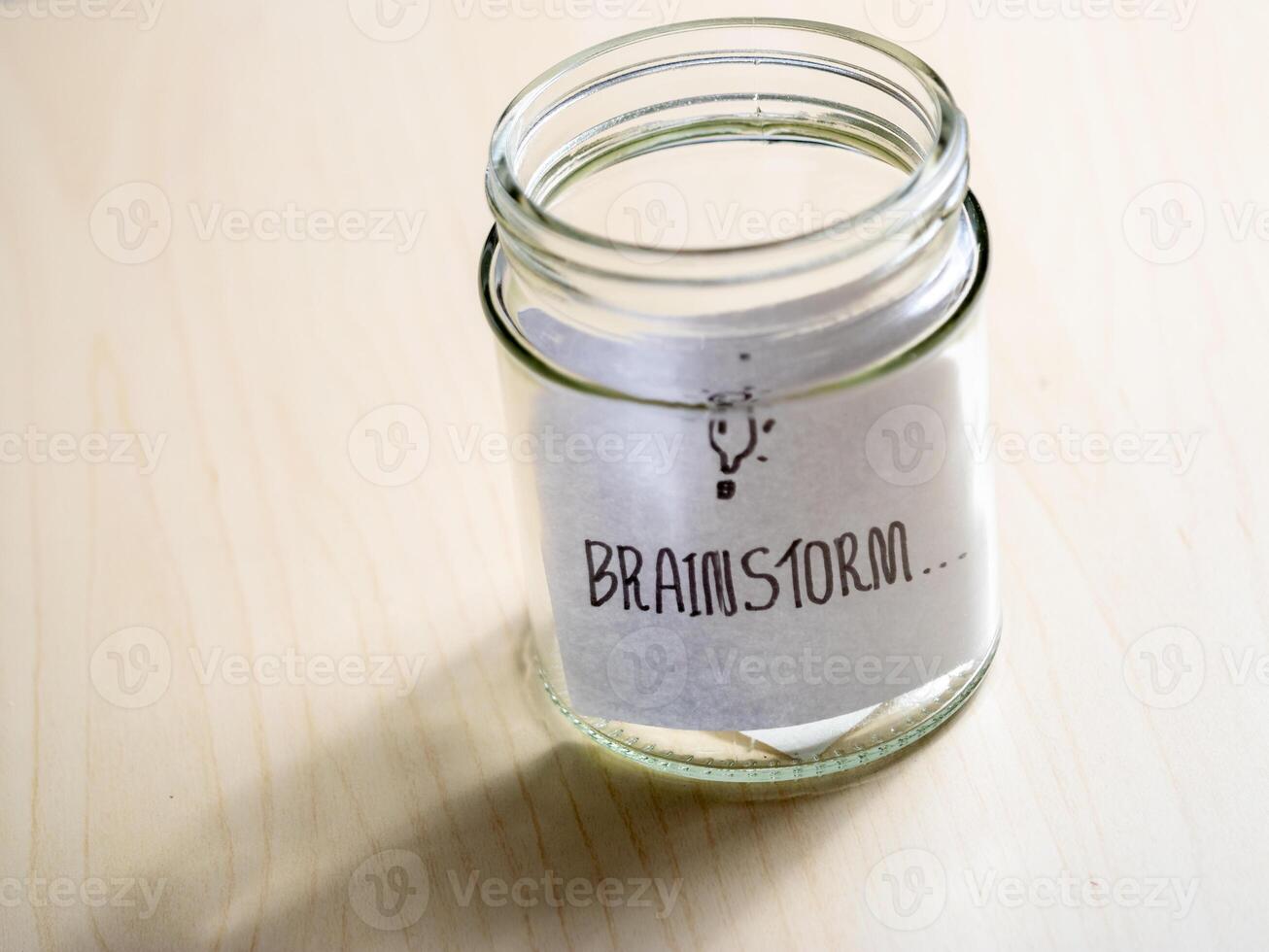 Close-up view of a glass jar in a minimalist home office brainstorming session photo