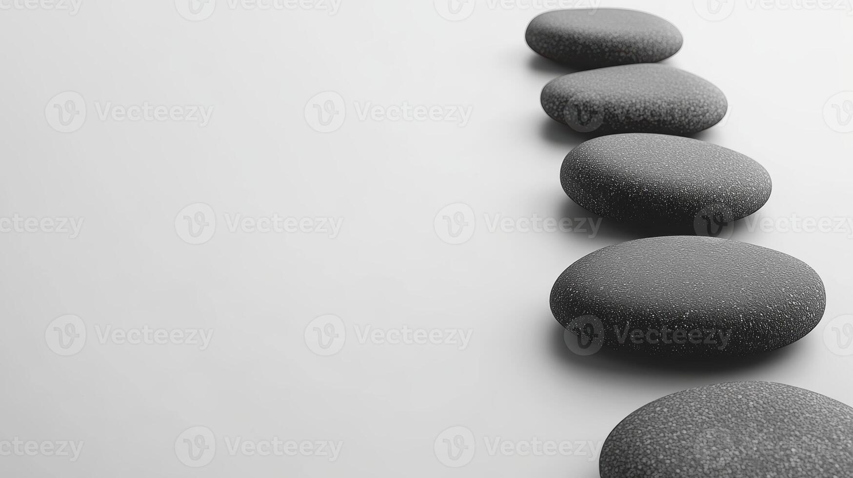 Minimalist black spa stones aligned against a soft white backdrop photo