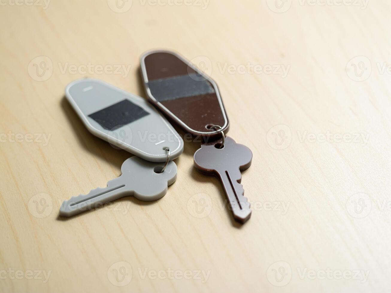 Key management home keys on wooden table close-up indoor minimalist concept for efficiency photo