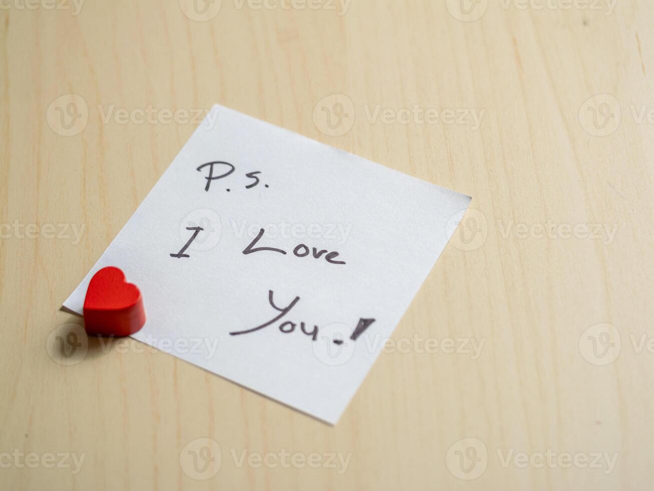 Close-up view of heartfelt love note with red heart personal message and emotional connection photo