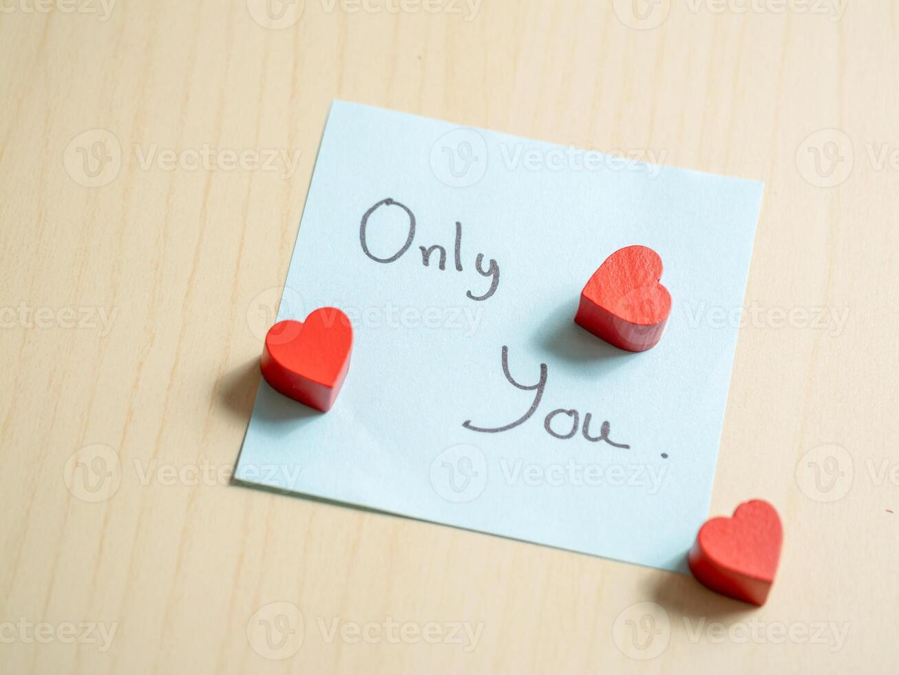 Romantic gesture heart-shaped tokens on note home digital intimate setting close-up love expression photo