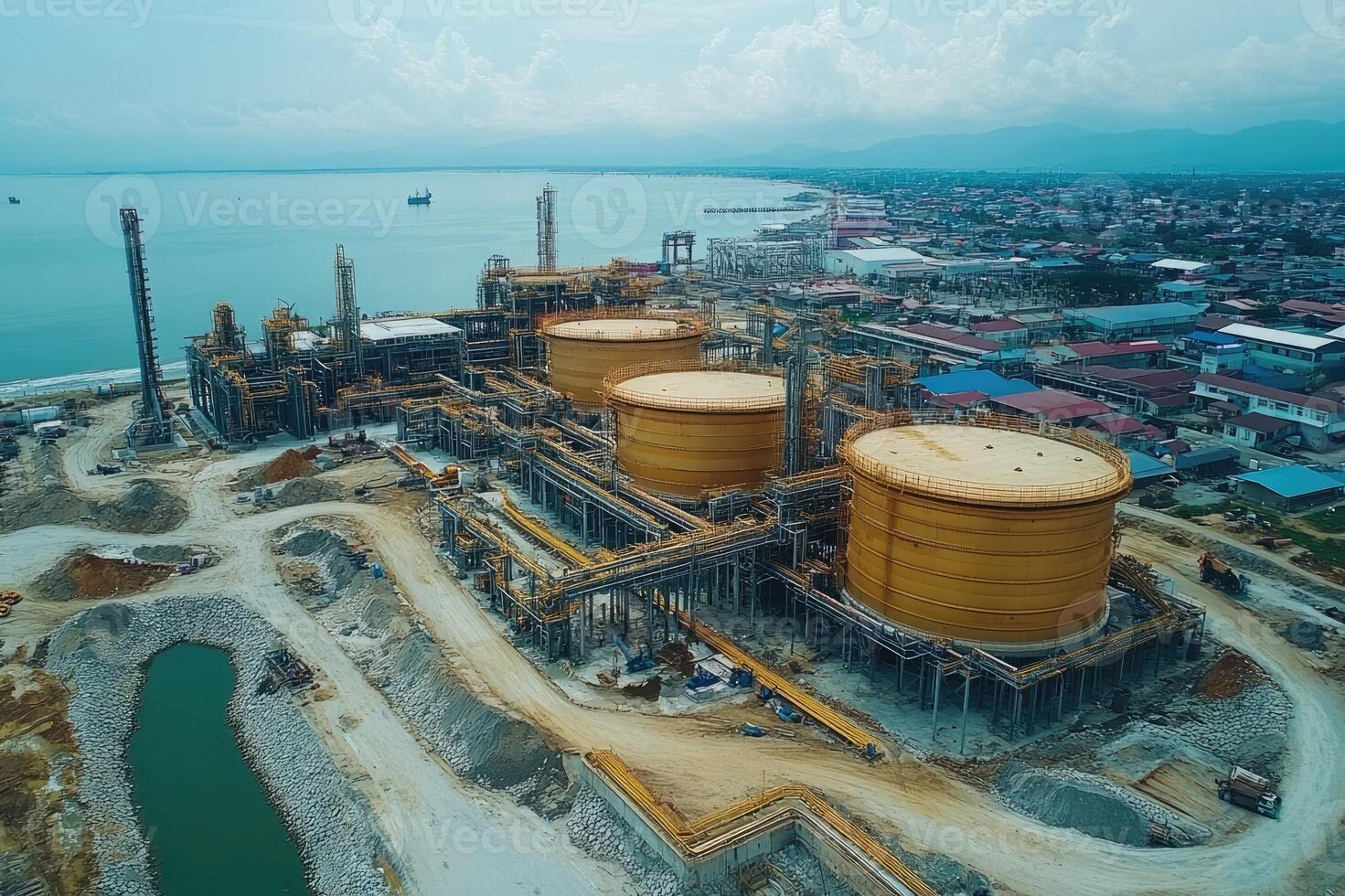 Oil refinery plant near the sea, showing storage tanks and processing units photo