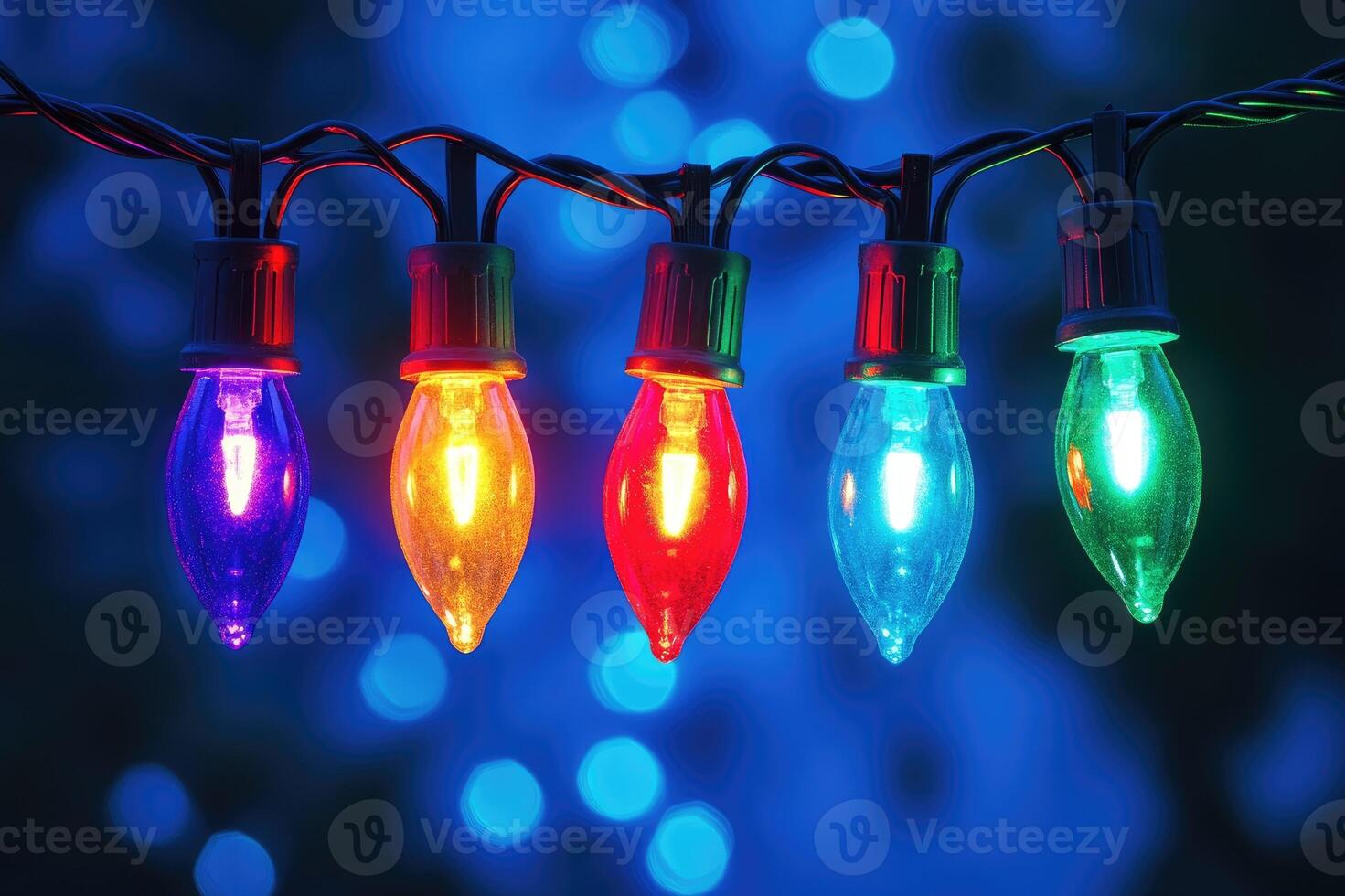 String of colorful christmas lights shining on blue background photo