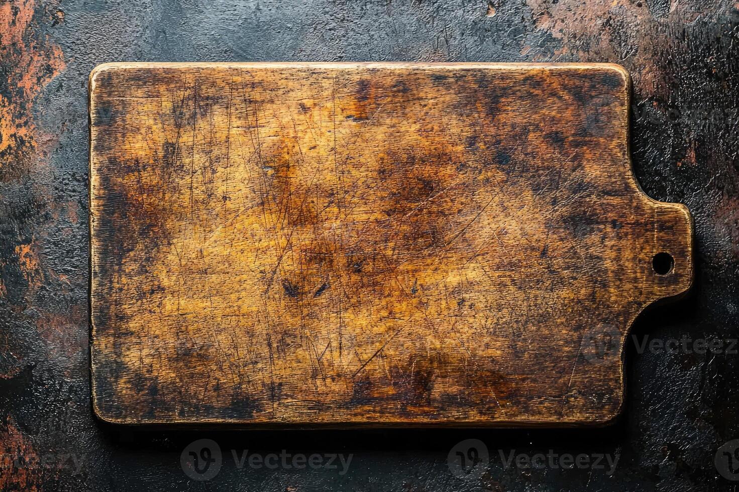 Rectangular empty dark wooden cutting board lying on black table photo