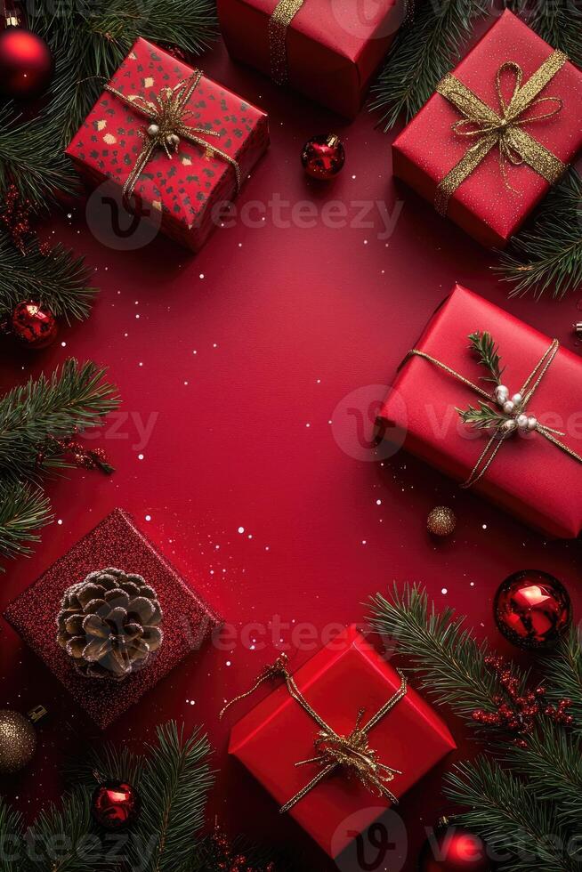 Christmas gifts, ornaments, and pine branches creating festive border on red background photo