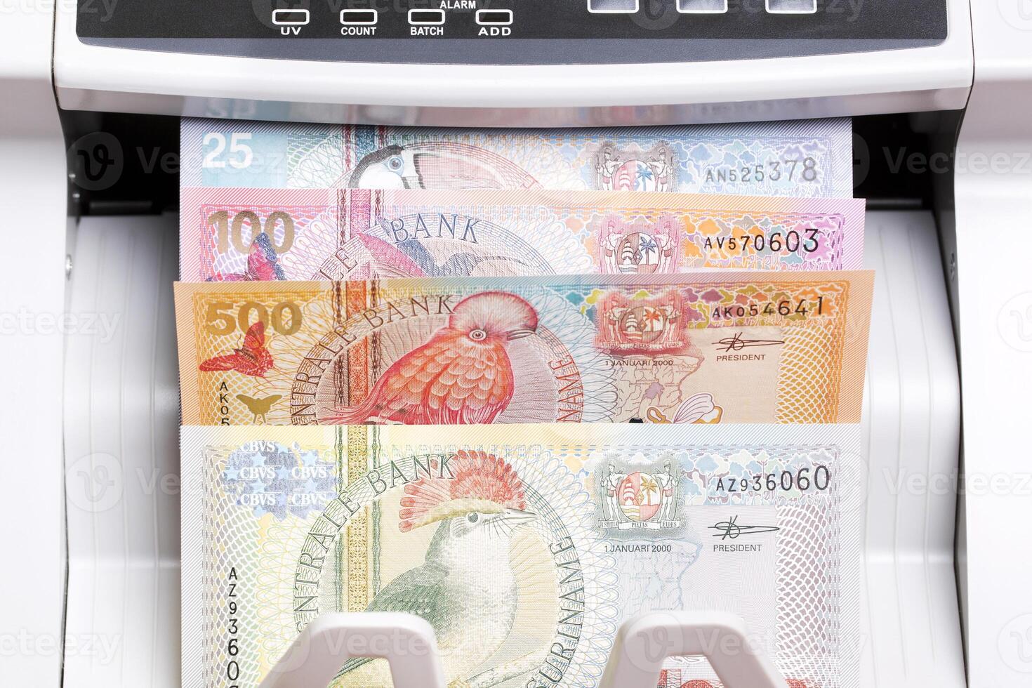 Surinamese dollar in the counting machine photo
