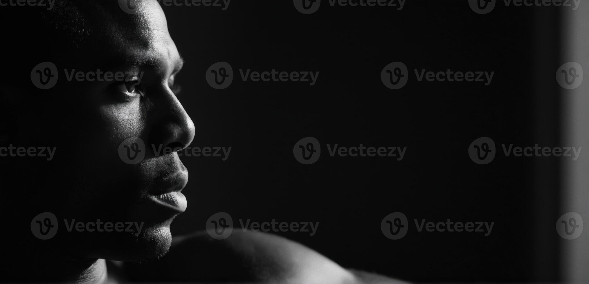 A man in black and white looking away from the camera photo