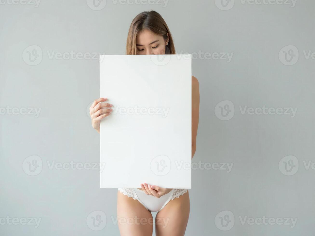 Minimalist composition of a woman holding a blank white board in a bright setting, perfect for mockups and branding visuals photo