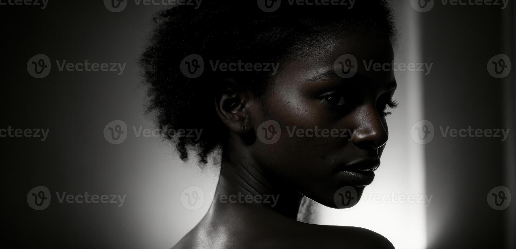 A black woman with a black background photo