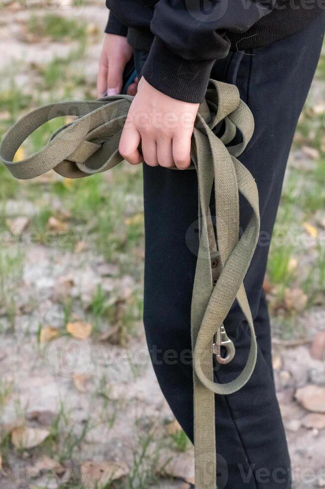 Child Holding a Green Climbing Rope Outdoors photo