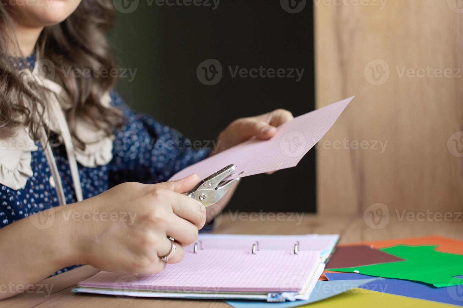 Creative Woman Crafting with Paper and Scissors at Desk photo