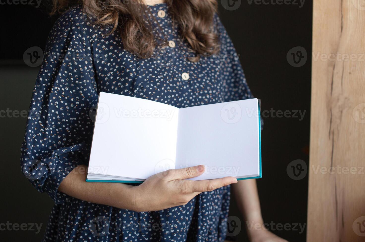 Woman Holding Blank Open Book Ready for Your Content photo