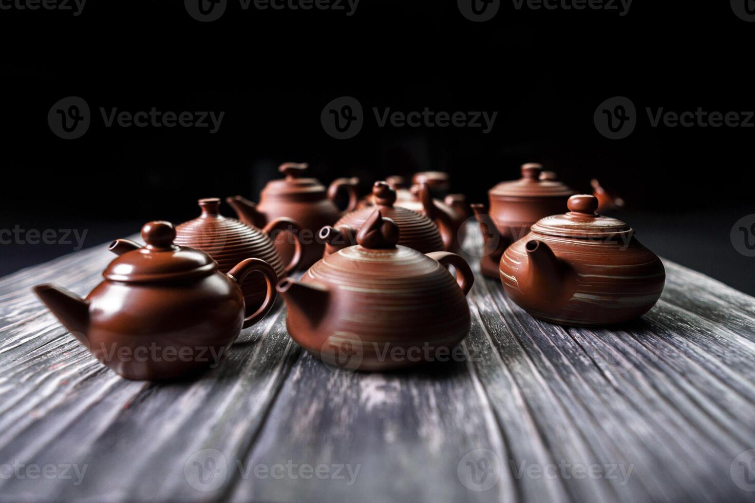 An Elegant Collection of Exquisite Traditional Teapots Beautifully Displayed on a Wooden Table photo
