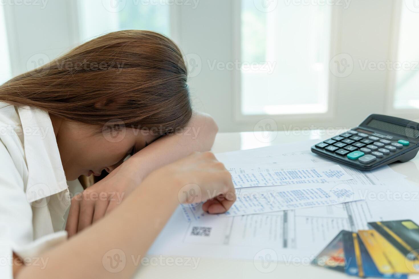 Stressed and headache asian woman with large bills or invoices no money to pay to expenses and credit card debt. shortage, Financial problems, mortgage, loan, bankruptcy, bankrupt, poor, empty wallet photo