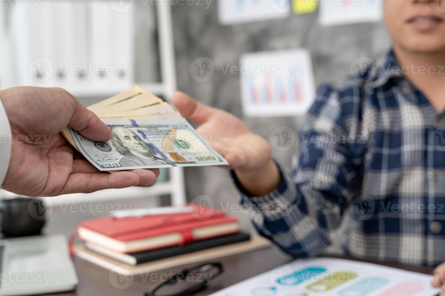 Businessmen receive salary or bonuses from management or Boss. Company give rewards to encourage work. Smiling businessman enjoying a reward at the desk in the office. photo