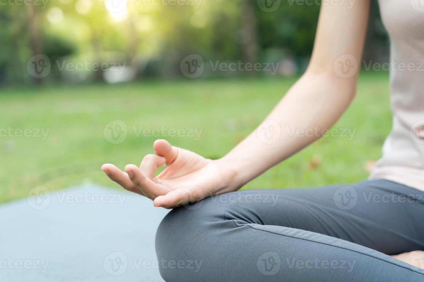 woman practicing meditate on the park. Asian woman doing exercises in morning. balance, recreation, relaxation, calm, good health, happy, relax, healthy lifestyle, reduce stress, peaceful, Attitude. photo