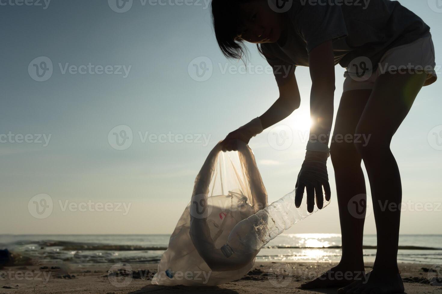 Save ocean. Volunteer pick up trash garbage at the beach and plastic bottles are difficult decompose prevent harm aquatic life. Earth, Environment, Greening planet, reduce global warming, Save world photo