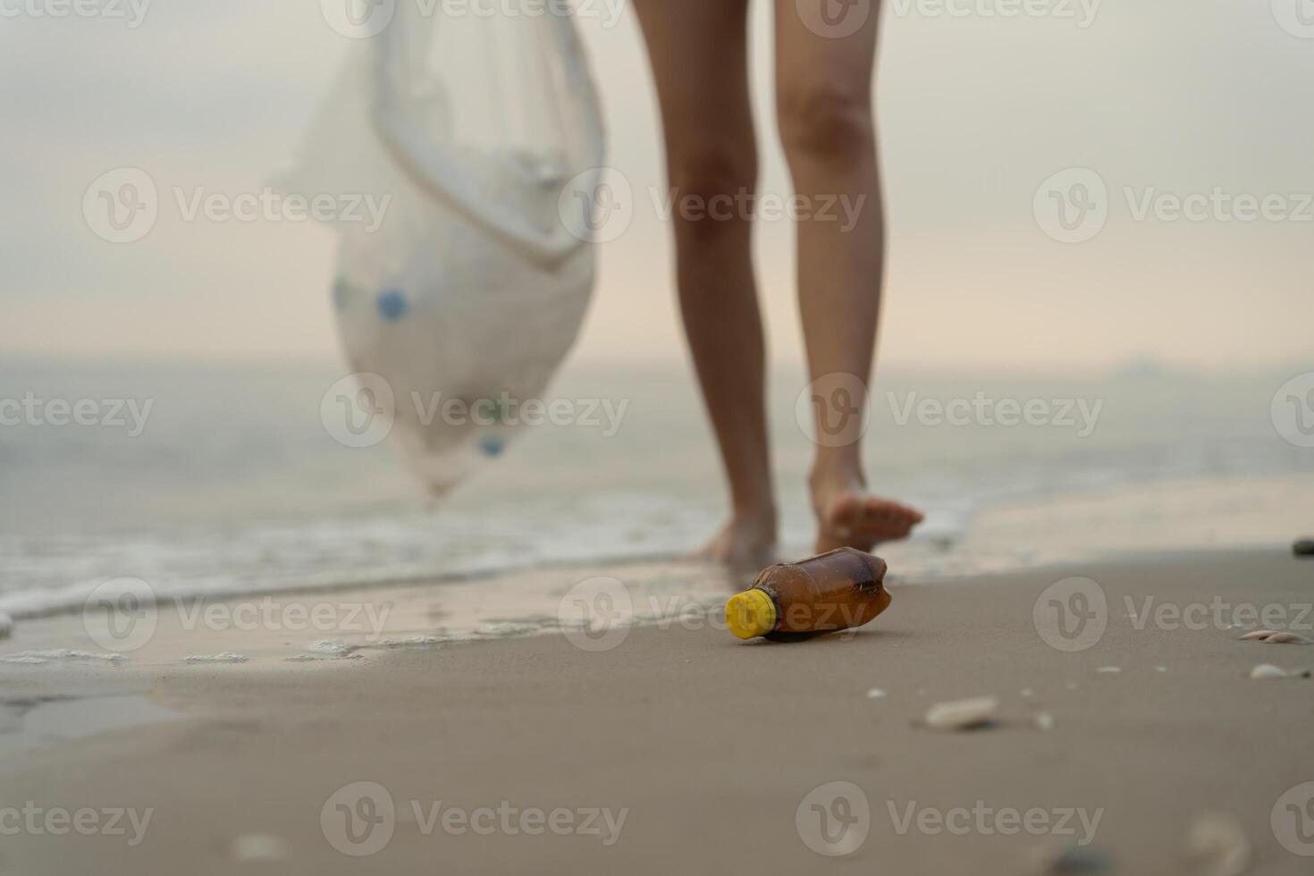 Save water. Volunteer pick up trash garbage at the beach and plastic bottles are difficult decompose prevent harm aquatic life. Earth, Environment, Greening planet, reduce global warming, Save worl photo