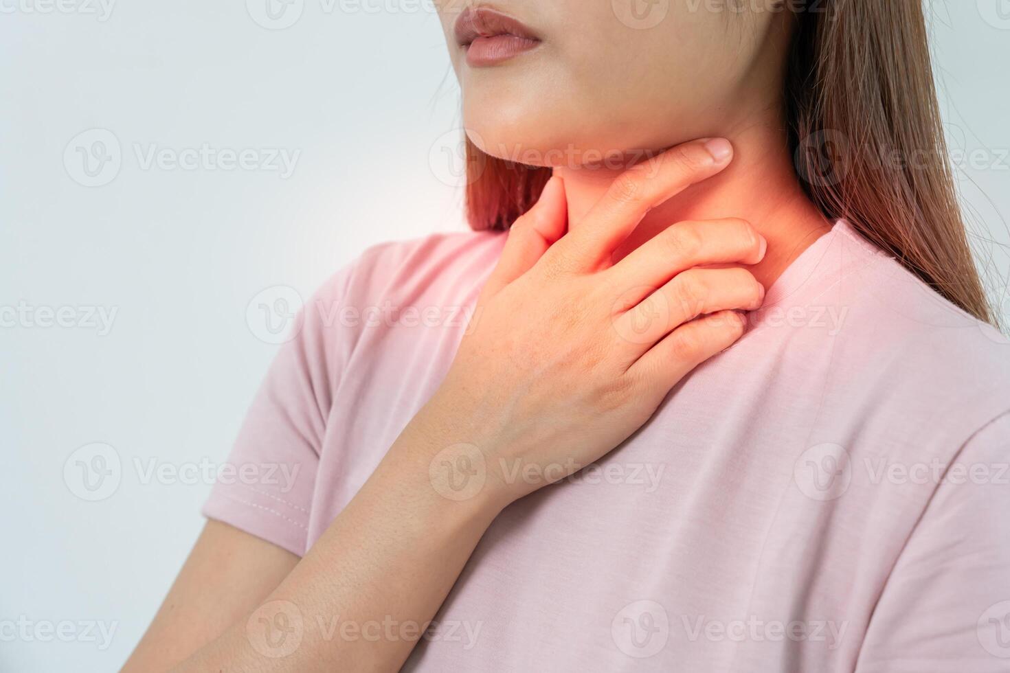 Asian woman put her hand on her neck due to a sore throat. female tonsillitis causes a inflammation. treated by taking water, taking antibiotics, consult a doctor, virus, corona virus, Influenza, flu photo