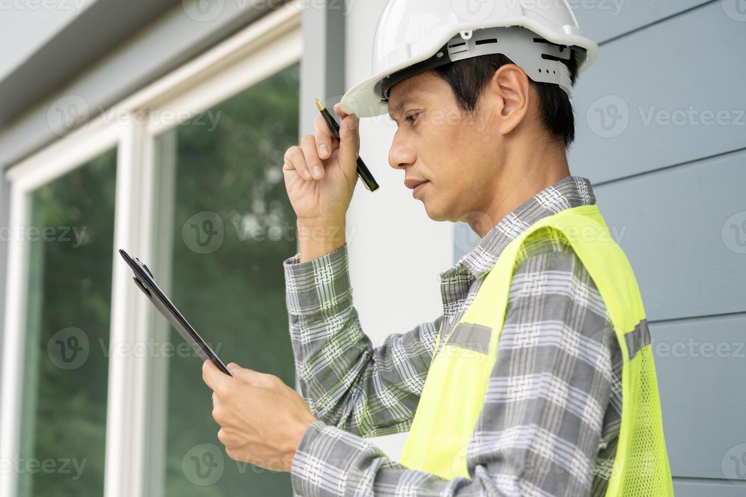 inspector or engineer is inspecting construction and quality assurance new house using a checklist. Engineers or architects or contactor work to build the house before handing it over to the homeowner photo