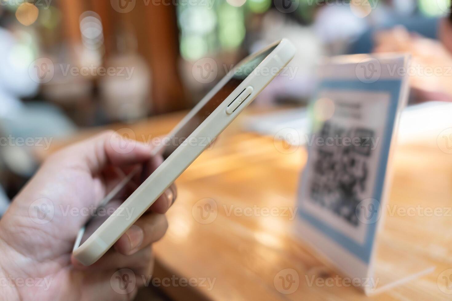 Woman use smartphone to scan QR code to pay in cafe restaurant with a digital payment without cash. Choose menu and order accumulate discount. E wallet, technology, pay online, credit card, bank app. photo