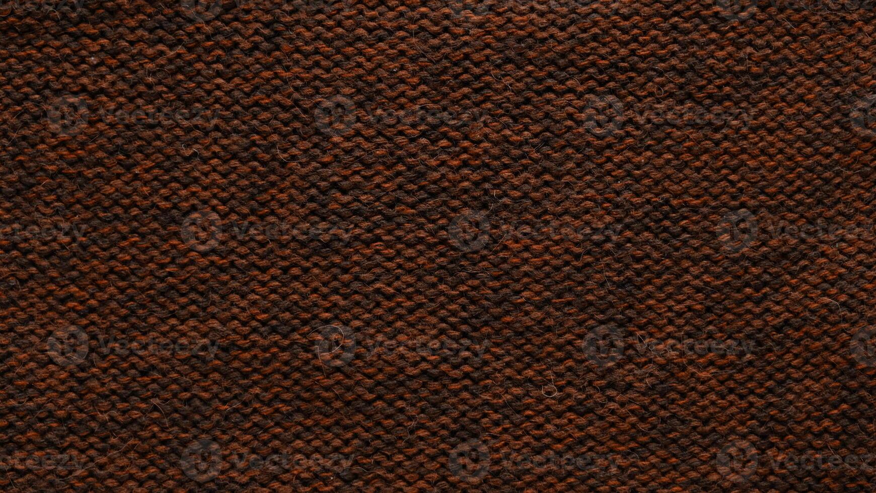 Texture of smooth knitted sweater with pattern. Handmade knitting wool or cotton fabric texture. Background of Large knit pattern with knitting needles or crochet. Mocha Mousse colour of 2025 year photo