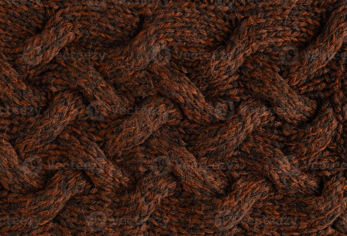 Texture of smooth knitted sweater with pattern. Handmade knitting wool or cotton fabric texture. Background of Large knit pattern with knitting needles or crochet. Mocha Mousse colour of 2025 year photo