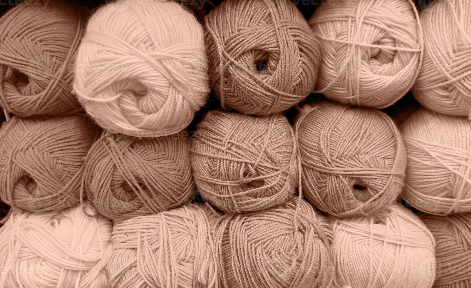 Colorful of Yarn Balls Wool in a Fabric Shop. Background from colored acrylic yarn. Skeins of thread close-up. Materials for needlework, for knitting and crocheting. Mocha Mousse colour of 2024 year photo
