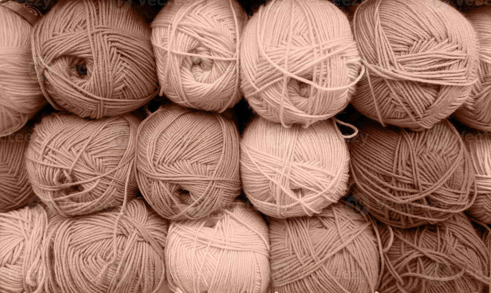 Colorful of Yarn Balls Wool in a Fabric Shop. Background from colored acrylic yarn. Skeins of thread close-up. Materials for needlework, for knitting and crocheting. Mocha Mousse colour of 2024 year photo
